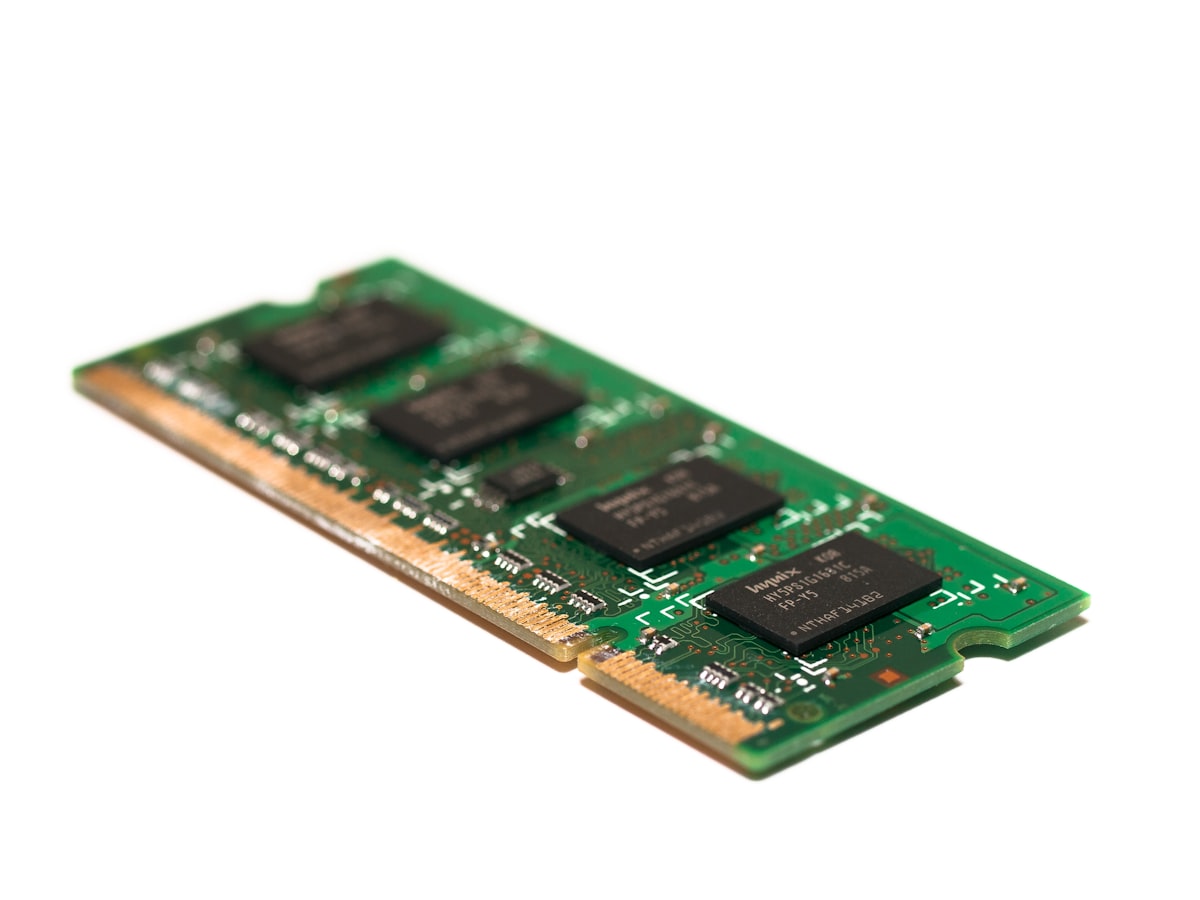 A laptop memory module angled to show its gold contact edge and notch, the part that seats into a socket, with no people, packaging or interface in frame