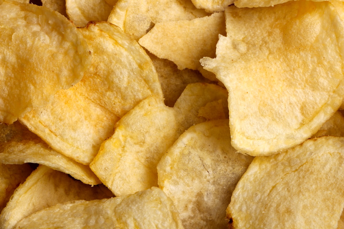 A close still life of plain, unbranded fried chips, no people and no readable brand or logo, for the piece weighing the observational case against ultra-processed food against the weaker causal trial evidence