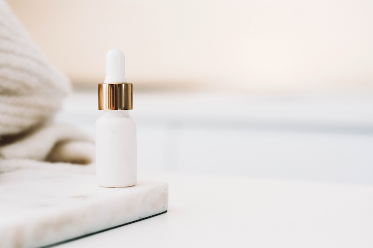 A plain unbranded dropper serum bottle on a white surface, no people and no readable brand or logo, for the piece on indie skincare brands out-growing the conglomerates