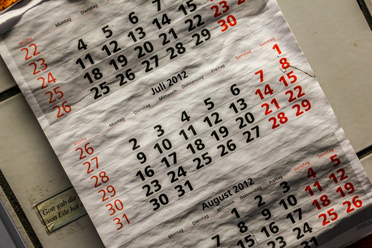 A creased paper wall calendar with the Saturday and Sunday dates printed in red; no people, no products, no brand or company marks, and not tied to any date the article discusses